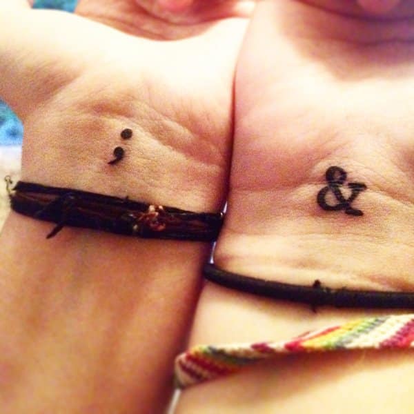semicolon tattoo on both wrists