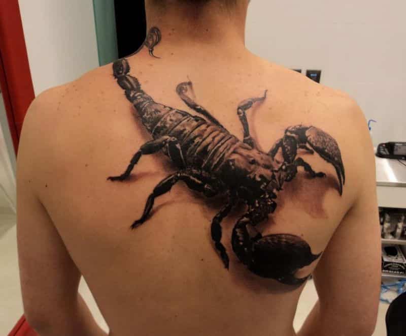 black ink scorpio tattoo on back