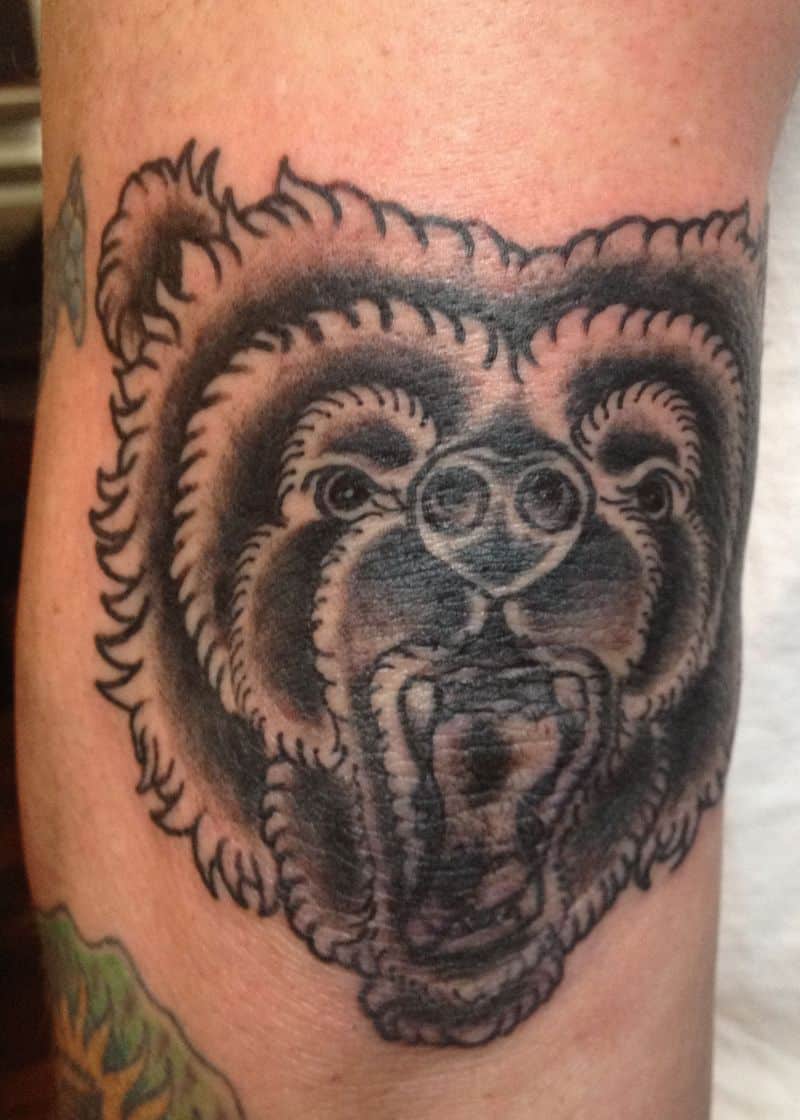 dark ink bear head elbow tattoo