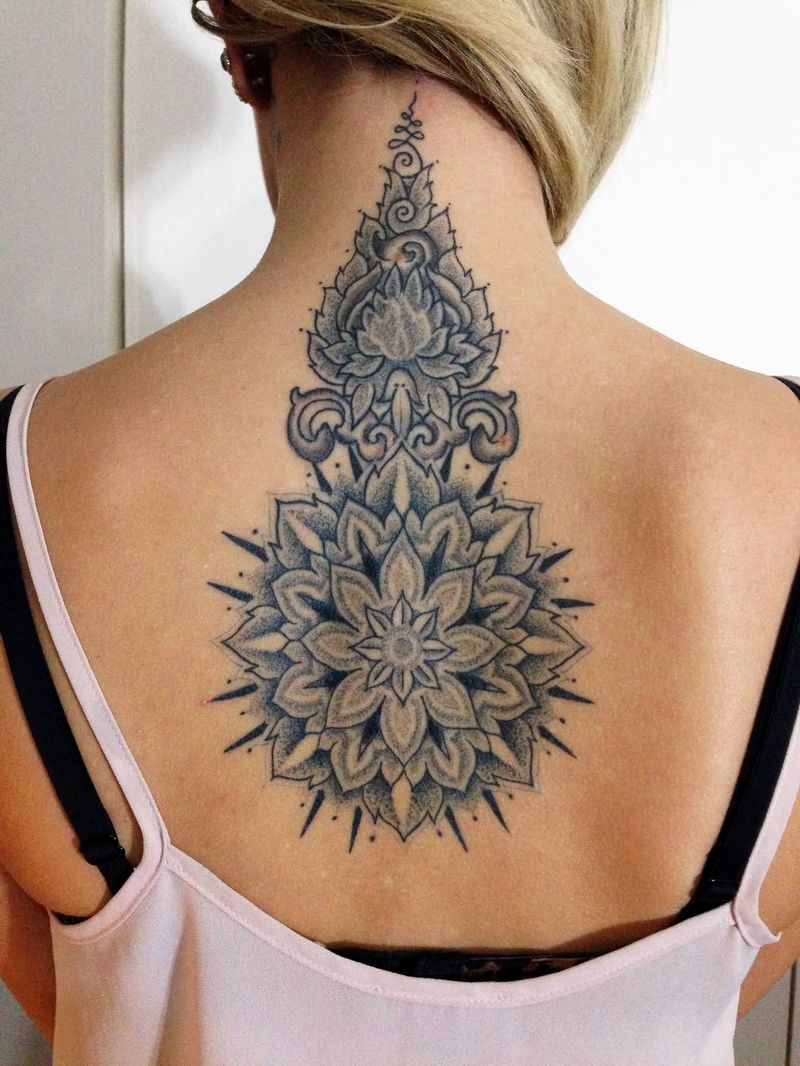 grey ink amazing flower tattoo design on girl spine