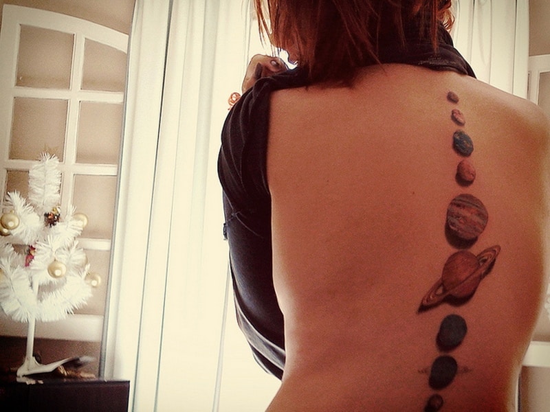 planets spine tattoo