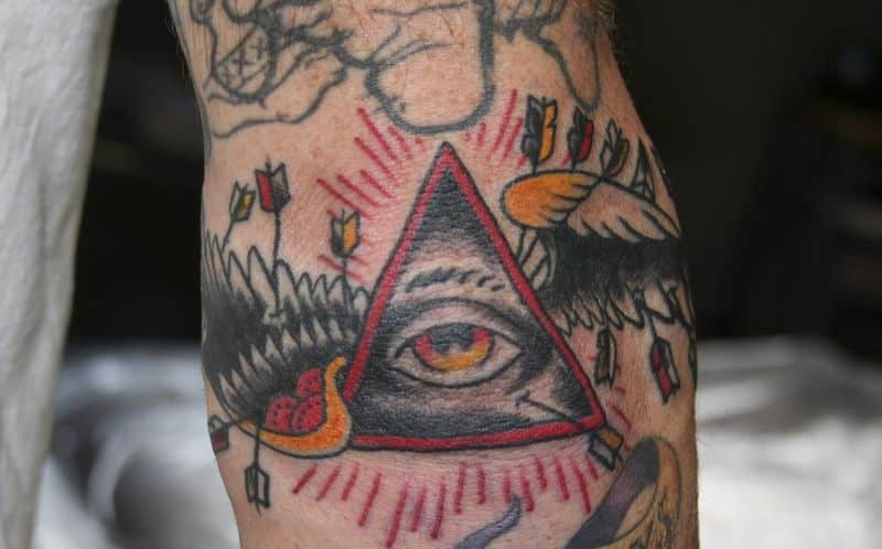 triangle eye elbow tattoo