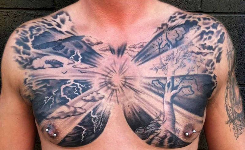 Black Ink Clouds With Tree Tattoo On Man Chest