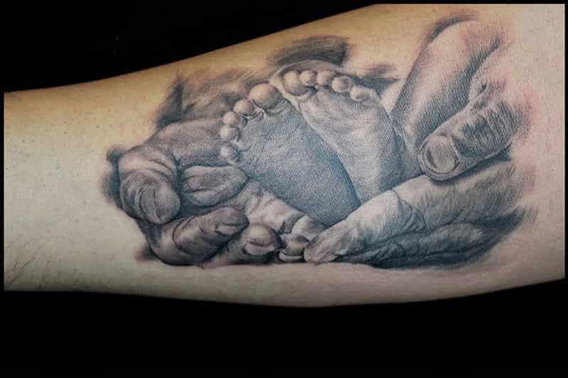 Grey 3D Daughter Feet On Hand Tattoo On Forearm